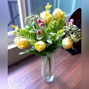 Faux flowers lights yellow roses with foliage in a vase